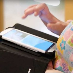 close up of hand touching an ipad